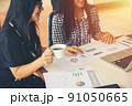 Two young asia business woman working together in office space 91050665