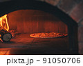 Italian pizza is cooked in a wood fired oven in stove 91050706