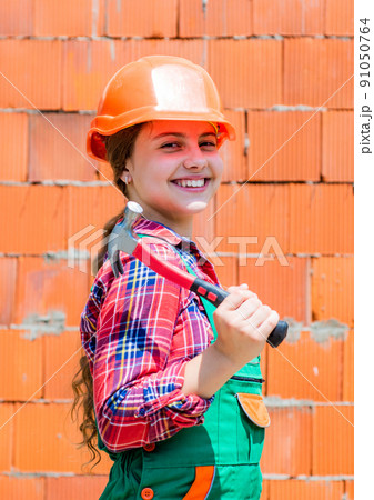 Repair concept. kid wear helmet on construction site Repair concept. kid wear helmet on construction site 91050764