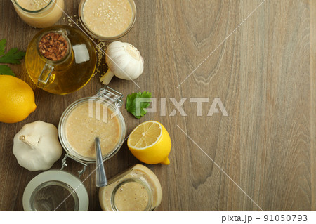Concept of tasty food with tahini sauce on wooden background 91050793