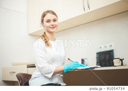 beautiful woman dentist in office, in clinic, indoor. Portrait, smiling and happy. Friendly doctor. young student of medical university beautiful woman dentist in office, in clinic, indoor. Portrait, smiling and happy. Friendly doctor. young student of medical university 91054734