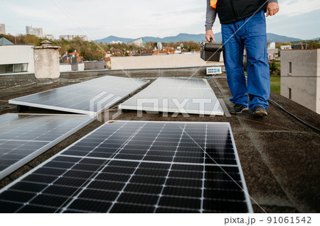 Men worker installing new solar panels. Eco concept alternative energy. Cover photo Men worker installing new solar panels. Eco concept alternative energy. Cover photo 91061542