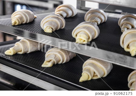 homemade croissants before baking on a baking sheet homemade croissants before baking on a baking sheet 91062175