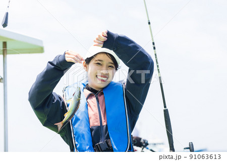 魚釣りをするかわいい女性 91063613
