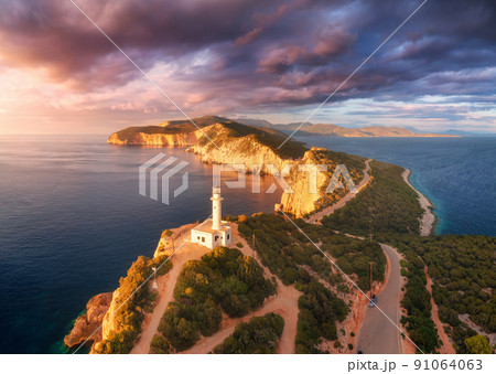 Lighthouse on the mountain peak at colorful sunset in summer 91064063