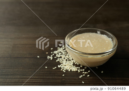 Concept of tasty food with tahini sauce on wooden background 91064489