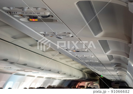 airplane interior view, aisle, chairs and ceiling airplane interior view, aisle, chairs and ceiling 91066682