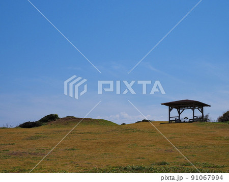 青空と草原にある東屋 91067994