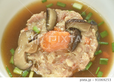 steamed chop pork topping salty egg yolk with mushroom in gravy sauce on bowl 91069253