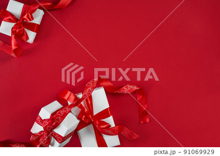 White gift boxes with red ribbon on red background. Valentines d White gift boxes with red ribbon on red background. Valentines d 91069929