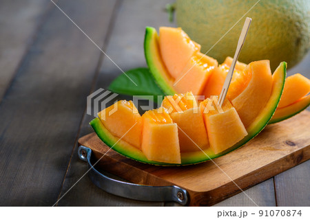 slice of japanese melons, orange melon or cantaloupe melon on wood slice of japanese melons, orange melon or cantaloupe melon on wood 91070874
