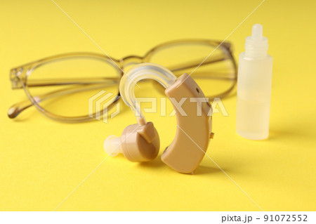 Concept of health care with hearing aid on yellow background 91072552