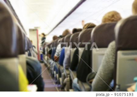 Blur background of passenger plane cabin 91075193