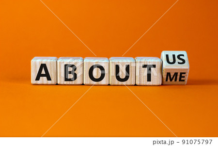 Turned a cube and changed the expression 'about me' to 'about us'. Beautiful orange background. Business concept. Copy space. Turned a cube and changed the expression 'about me' to 'about us'. Beautiful orange background. Business concept. Copy space. 91075797