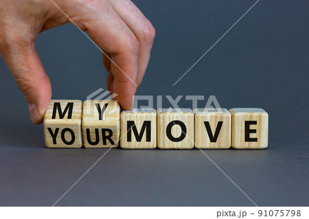 My or your move symbol. Businessman turns wooden cubes and changes words 'your move' to 'my move'. Beautiful grey table, grey background. My or your move and business concept. Copy space. My or your move symbol. Businessman turns wooden cubes and changes words 'your move' to 'my move'. Beautiful grey table, grey background. My or your move and business concept. Copy space. 91075798