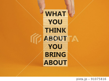 Think about bring about symbol. Wooden blocks with words What you think about you bring about. Beautiful orange background. Businessman hand. Business, motivational think or bring concept. Copy space. 91075816