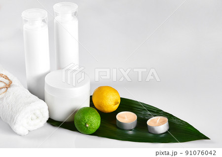White cosmetic products and green leaf on white background. Natural beauty products for branding mock-up concept. White cosmetic products and green leaf on white background. Natural beauty products for branding mock-up concept. 91076042