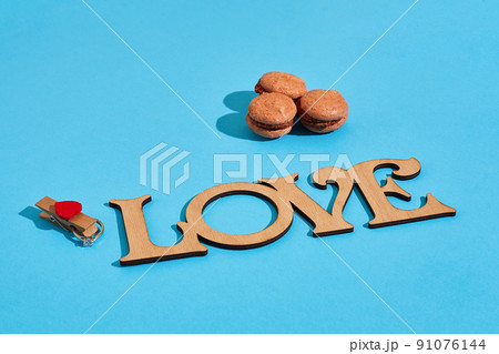 Macaroons on a blue background with the words I love spelt out i Macaroons on a blue background with the words I love spelt out i 91076144