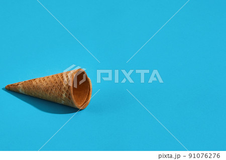 Waffle ice cream cones with shadow on a blue background 91076276