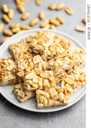 Sweet peanut bars on plate. 91076487