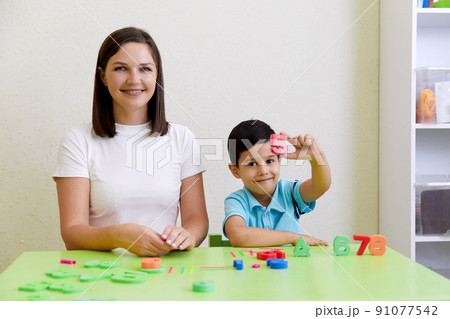Children practice correct pronunciation with speech therapist Children practice correct pronunciation with speech therapist 91077542
