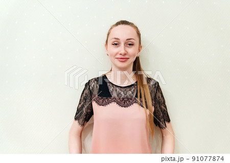 a young woman with long hair in a black and pink blouse with lace. 91077874
