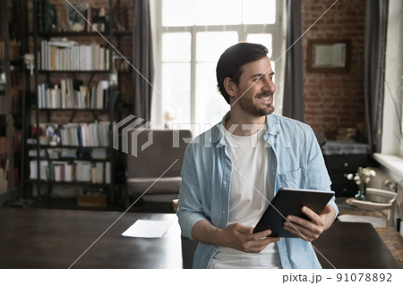Businessman use apps on digital tablet staring aside feels satisfied 91078892
