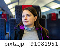Woman sitting on her seat while traveling by train 91081951
