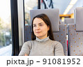 Portrait of woman sitting inside train 91081952