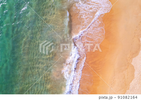 Sea background Aerial view Top down sea waves crashing on sandy beach beautiful sand sea surface in Phuket thailand 91082164