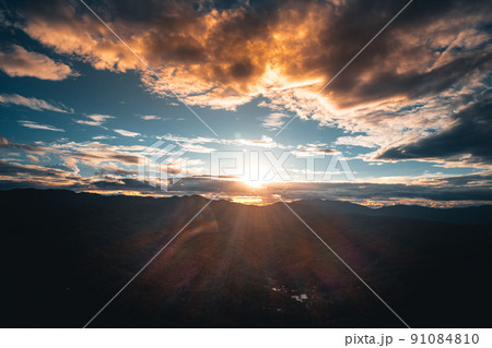 mountains and green trees in the evening mountains and green trees in the evening 91084810