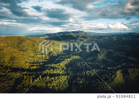 mountains and green trees in the evening mountains and green trees in the evening 91084811