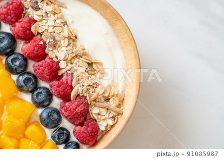 homemade yogurt bowl with raspberry, blueberry, mango and granola homemade yogurt bowl with raspberry, blueberry, mango and granola 91085987