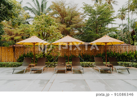 umbrella and pool bed around swimming pool umbrella and pool bed around swimming pool 91086346