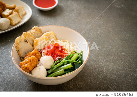 egg noodles with fish balls and shrimp balls in pink sauce, Yen Ta Four or Yen Ta Fo 91086462