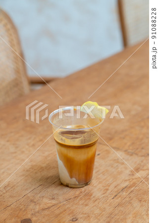 Specialty coffee menu called 'Dirty coffee' . Cold milk in the bottom with hot espresso shot on top 91088228