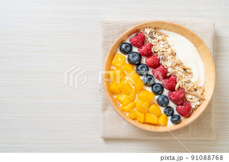 homemade yogurt bowl with raspberry, blueberry, mango and granola 91088768