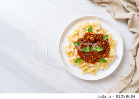 farfalle pasta with basil and garlic in tomato sauce 91089684