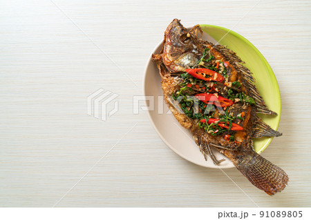 Fried Tilapia Fish with Basil chili garlic sauce 91089805