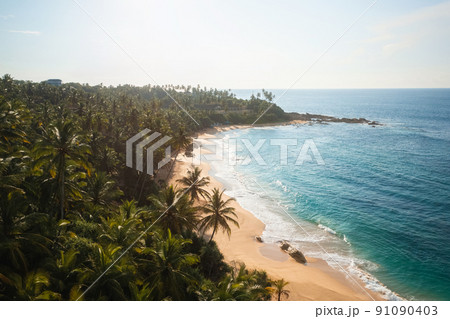 Beautiful sandy beach with palm trees and sea surf with waves. Silent Beach, Sri Lanka. 91090403