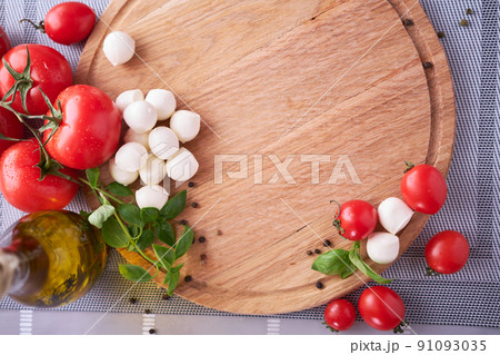 Ingredients for Caprese salad - Mini mozzarella cheese in glass bowl, tomato and basil Ingredients for Caprese salad - Mini mozzarella cheese in glass bowl, tomato and basil 91093035