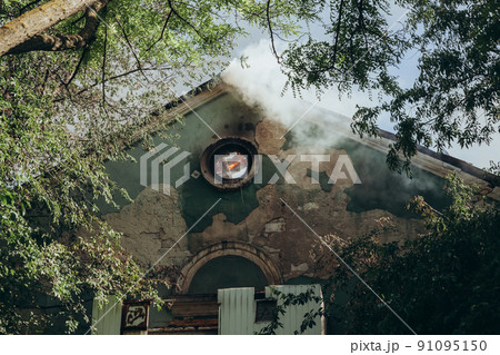 A fire on the roof of an old abandoned building A fire on the roof of an old abandoned building 91095150