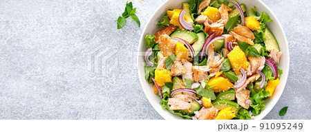 Grilled salmon and mango salad with avocado and fresh green lettuce. Banner 91095249