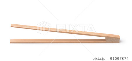 Side view of wooden kitchen tongs Side view of wooden kitchen tongs 91097374