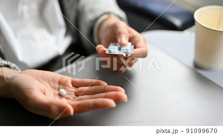 Close-up, An airsick motion sickness pill on a female hand. Healthcare concept. 91099670