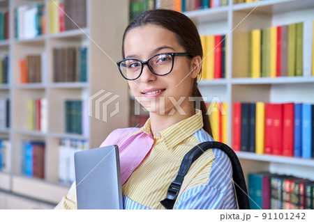 Portrait of high school student looking at camera in library 91101242