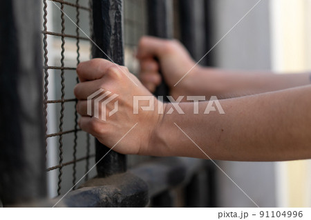 Girl stressed trapped in steel cage.The concept of violence against woman. 91104996