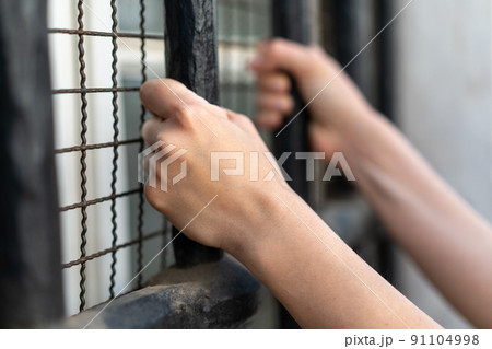 Girl stressed trapped in steel cage.The concept of violence against woman. Girl stressed trapped in steel cage.The concept of violence against woman. 91104998