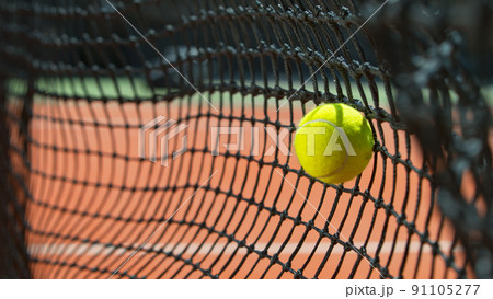 Freeze motion shot of tennis ball hitting the net 91105277