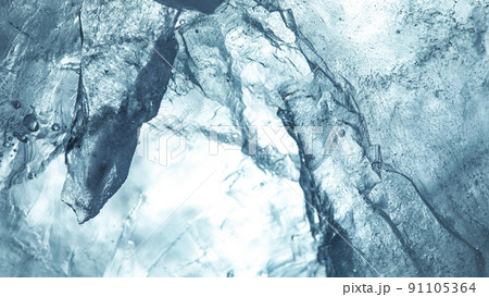 Abstract ice texture. A network of cracks on a piece of blue ice 91105364